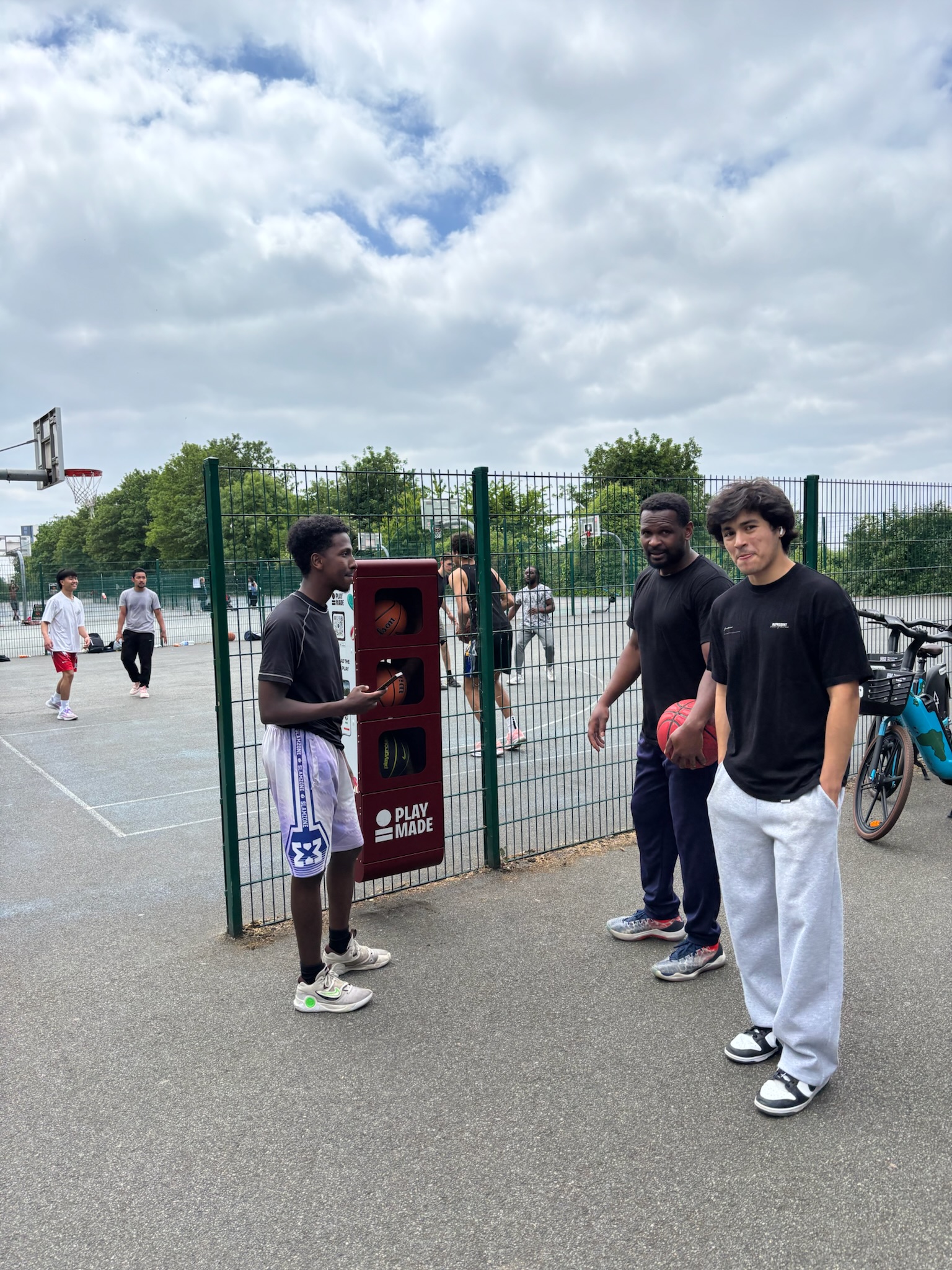 Teens chilling by basketball court in autumn